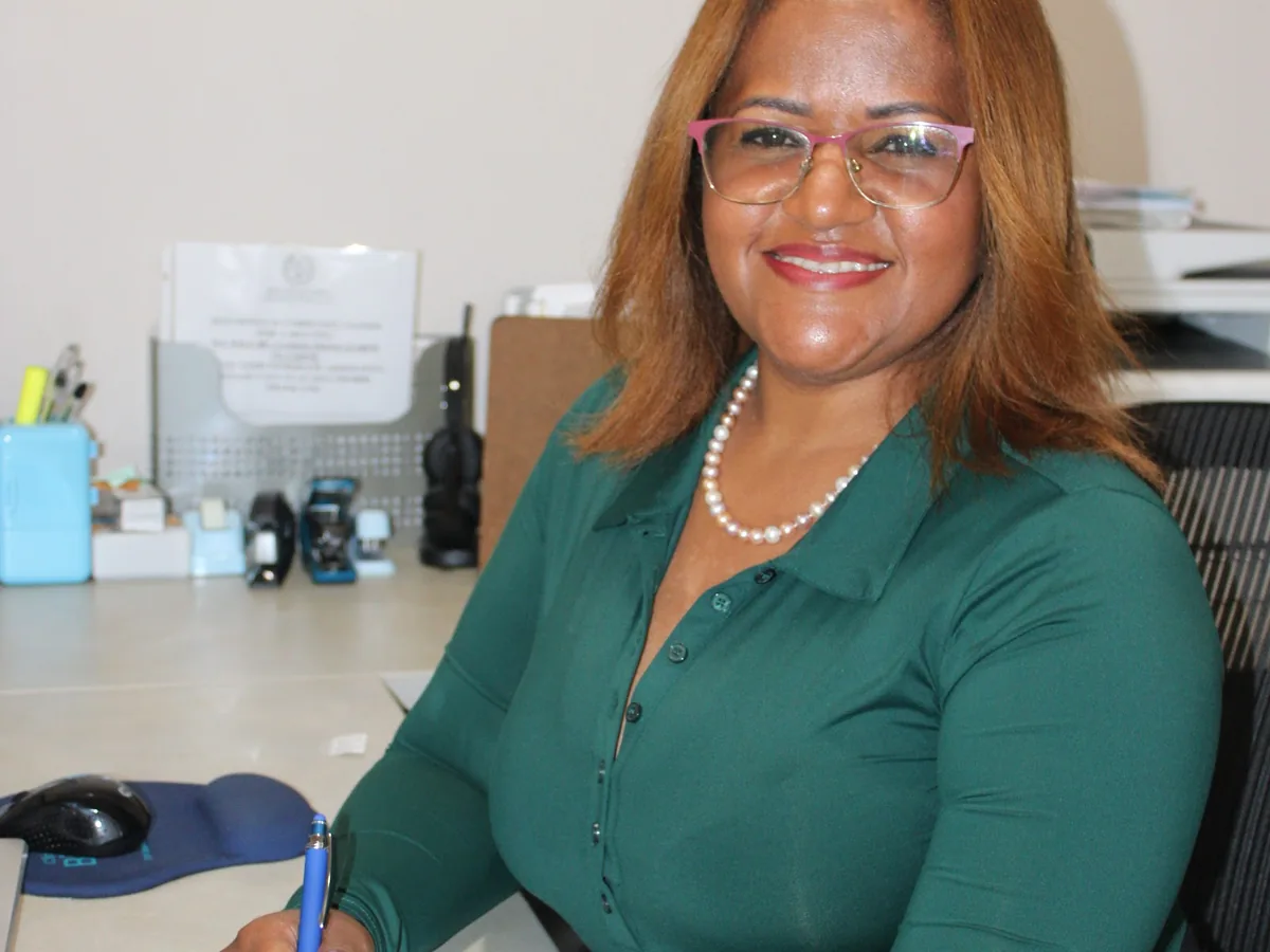 Evelyn Mateo taking notes on a case at the Melgar Law Firm office in Hauppauge